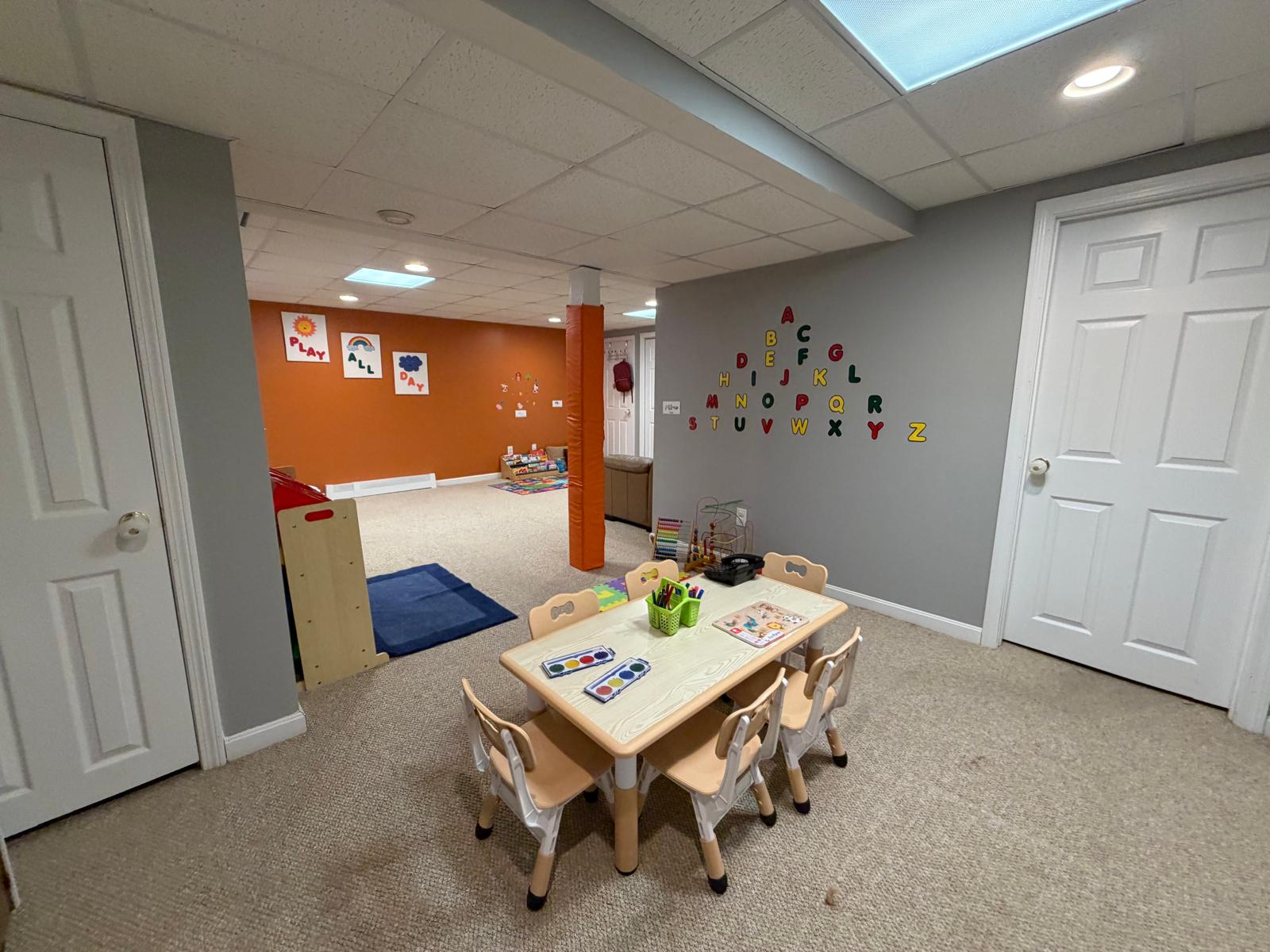 The alphabet wall above a number play mat, abacus, and bead maze for STEM learning